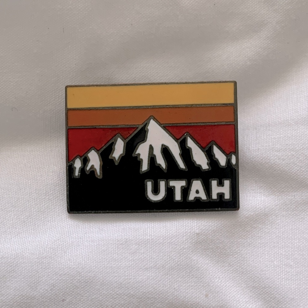 Substantial vintage Utah pin with partial rainbow stripe.